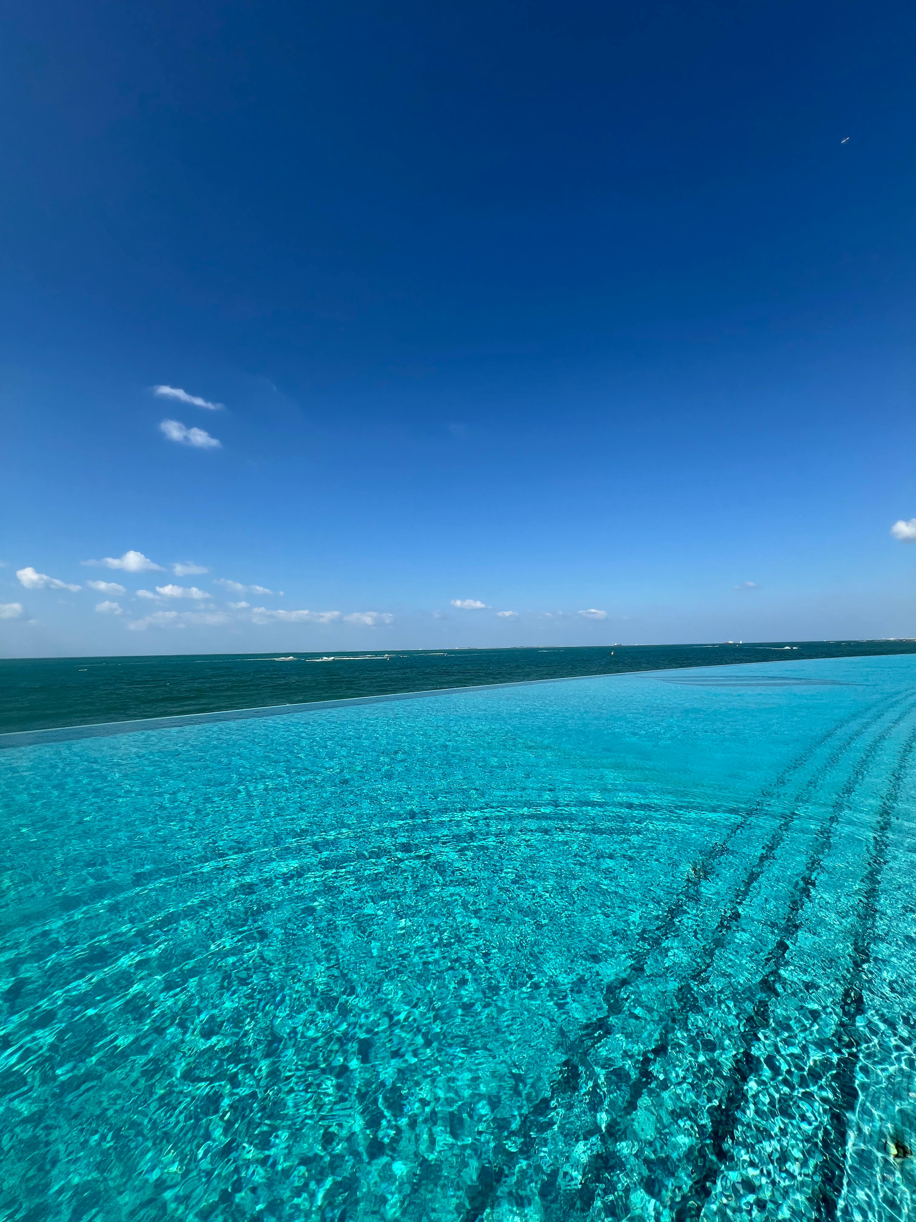 Luxury infinity pool meeting the deep blue ocean